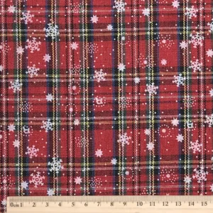 white snowflake printed on red stewart tartan plaid fabric